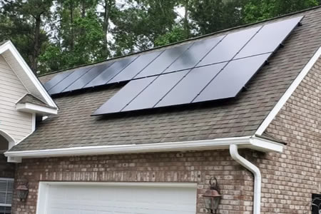 Lakeside moncks corner home with a clean solar array reflecting afternoon sun